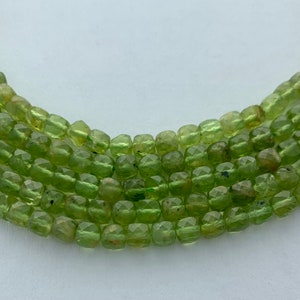 4mm Peridot precision faceted cube gemstone beads.  15&quot; strands of high quality faceted cubes, approximately 86 per strand.