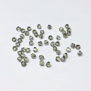 Jonquil Satin 4mm Bicone SWAROVSKI® Crystal Beads #5301 package of 50. Yellow with iridescent finish Genuine Austrian Crystal. Bulk #5328.