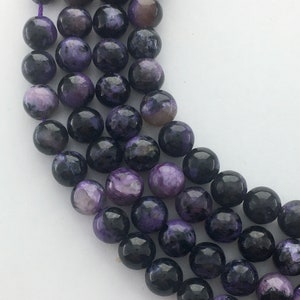 6mm Dark Russian Charoite Gemstone Beads.  15&quot; strand of high quality beads, about 62 beads per strand.  Mixed purples with black and white.