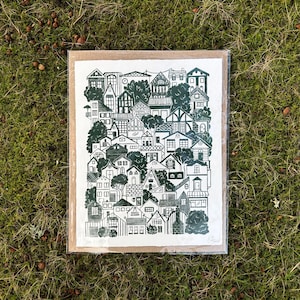 The same print, packaged in a plastic sleeve with a sheet of cardboard.