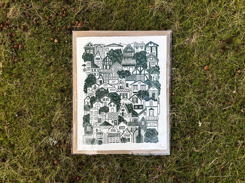 The same print, packaged in a plastic sleeve with a sheet of cardboard.