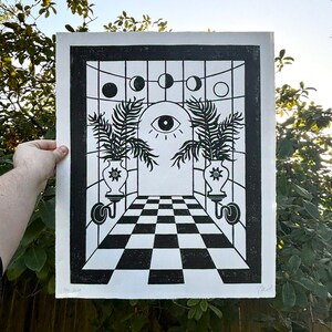 behind the door moons and palms, thin black perspective lines cross over each other. the vertical lines are straight but horizontal lines curve, giving the impression that the room is rounded. the effect is visual symmetry but vestibular uneasiness