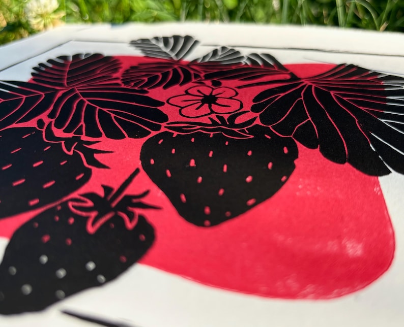 closeup of the print showing the details the leaves, which are black with white veins running down the length of each leaf and from the center vein to the edge of each leaf at an upward angle.