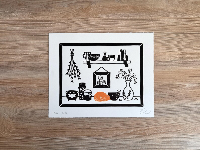 the same print laying on a light wood background.