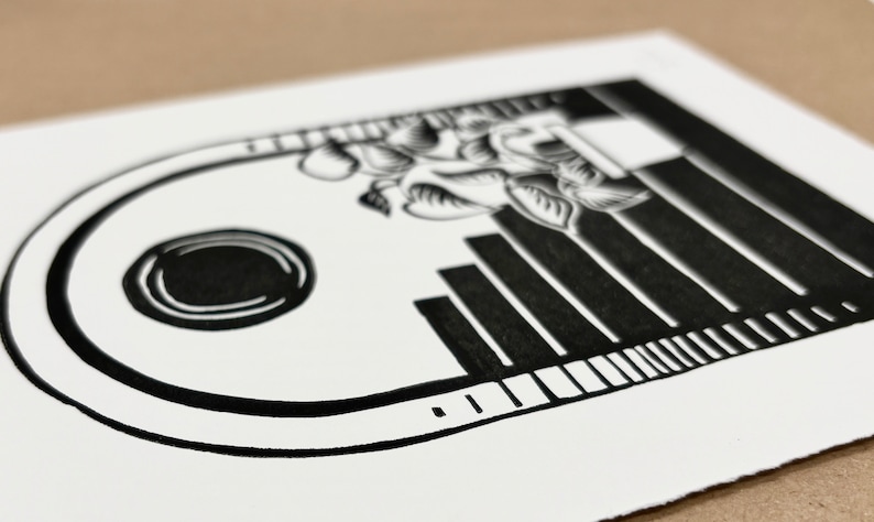 Angled closeup of the daytime linocut print. The outermost half-inch of the arch has a shading pattern on the left and right sides made of horizontal lines, going from black at the bottom to white on top.