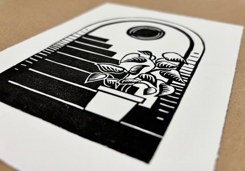 Angled close-up of the daytime archway print. The plant is in a large white pot on the bottom stair. The leaves of the plant have hatching shading lines. The sun  sits in the center of the sky under the arch and has thin white lines around its edges.