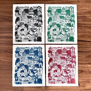 The green houses print next to red, black, and blue versions of the same print.