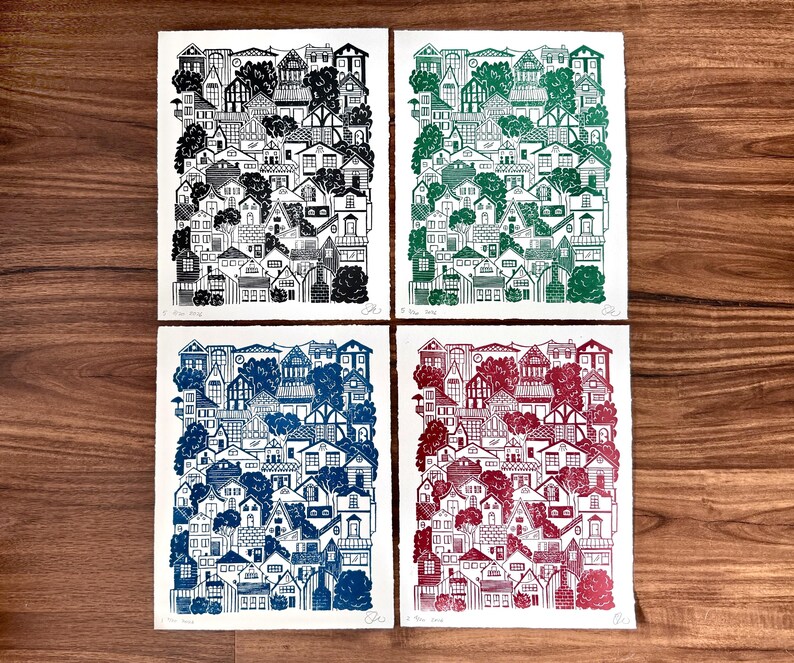 The green houses print next to red, black, and blue versions of the same print.