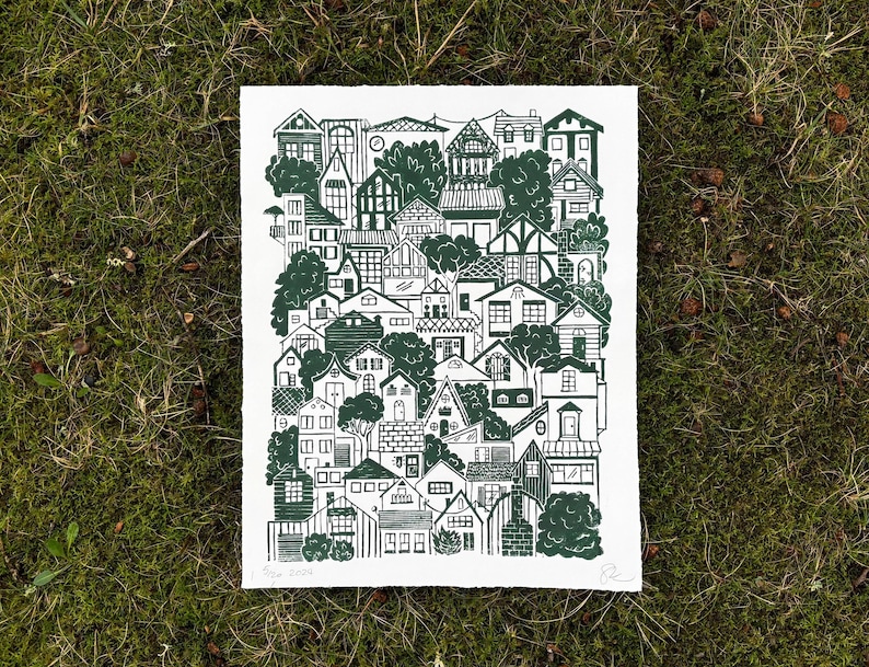 a large linocut print with dark green ink on white paper. it shows roughly fifty houses in a variety of architecture styles stacked on top of each other as though sitting on a hillside. trees and bushes poke out from between the houses.