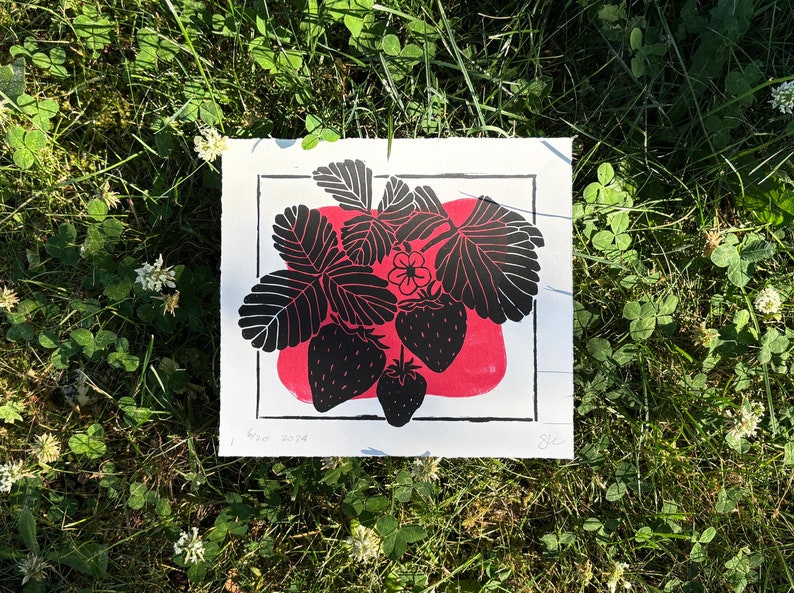 the same print on clovers and grass with small white clover flowers around it