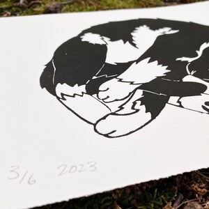 Closeup of the print. The year 2023 and print edition 3 of 6 are written in the lower left corner of the print. The edges of the paper are torn for a rustic look.