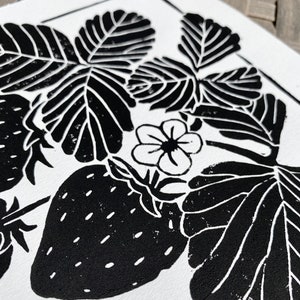 a close-up of the print, showing the details of a strawberry, blossom, and a few leaves.