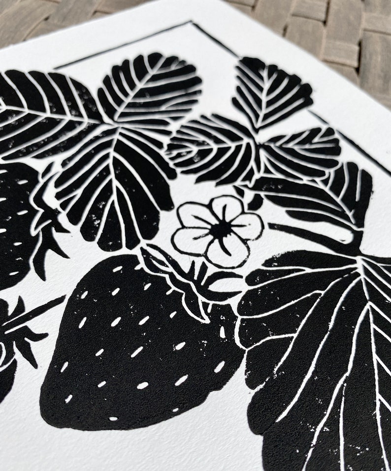 a close-up of the print, showing the details of a strawberry, blossom, and a few leaves.