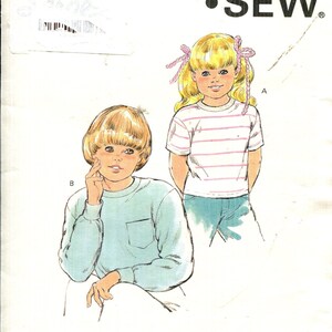 May include: A white ceramic mug with a black handle and the text "But First, Coffee" in a handwritten style. The mug is on a white surface. The mug is approximately 4 inches tall.