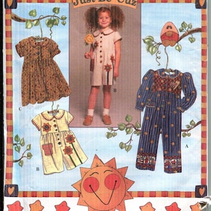 May include: Simplicity pattern 7089 for children's clothing. The pattern features three different outfits: a dress, a romper, and a jumpsuit. The image includes the text "Just Be 'Cuz".