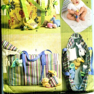 May include: A sewing pattern for baby items, including tote bags and a changing pad. The bags feature animal and striped patterns. The pattern includes a baby sitting on a changing pad and stuffed animals.