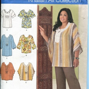 May include: Simplicity sewing pattern 2230, Khaliah Ali Collection, featuring various top designs. The pattern includes sizes AA 10, 12, 14, 16, and 18. The image shows a woman wearing a striped top and brown pants.