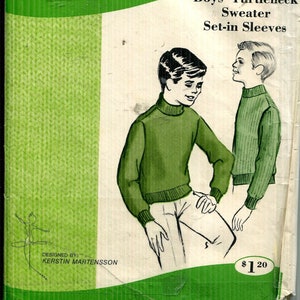 May include: Vintage sewing pattern for a boys' turtleneck sweater with set-in sleeves. The cover features illustrations of two boys wearing green sweaters. The pattern is designed for sweater fabric and is for ages 8-10-12. The pattern is from Sew-Knit-N-Stretch, Inc.