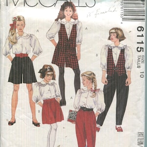May include: McCall's sewing pattern for children's clothing, featuring various outfits. The illustrations show a white blouse with a ruffled collar, paired with shorts, skirts, pants, and a plaid vest. The pattern includes sizes and measurements.