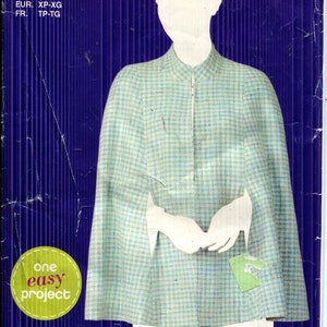 May include: Simplicity E2030 sewing pattern. The pattern features a cape design with a light blue and white checkered pattern. The package includes the text "one easy project" and size information.