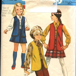 May include: Vintage Simplicity pattern envelope featuring three children's outfits. The envelope displays the number 8428 and the text "Simplicity Fashion Magazine". The outfits include vests, skirts, and pants.