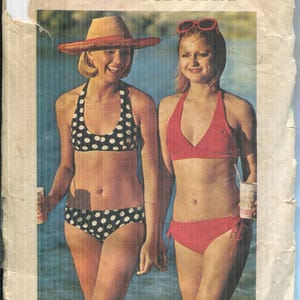 May include: Vintage sewing pattern cover featuring two women in bikinis. One wears a polka dot bikini and a straw hat, the other a red bikini. The text reads "THE EVERY-BODY BIKINI™" and "FOR STRETCH KNITS ONLY".