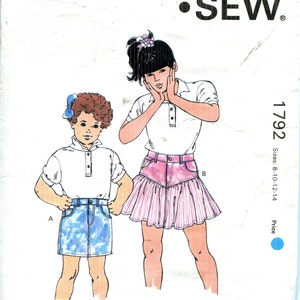 May include: Kwik Sew pattern 1792 features illustrations of two young girls wearing different skirt styles. The pattern includes sizes 8-10-12-14. The design is by Kerstin Martensson.