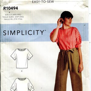May include: Simplicity pattern R10494, featuring a woman in a red and white striped top and brown pants. The pattern includes illustrations of two different sleeve styles. The text "EASY-TO-SEW" is displayed at the top.