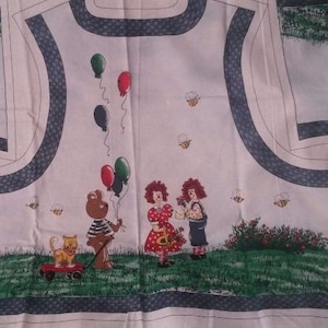 May include: White fabric with a whimsical illustration featuring a teddy bear holding balloons, two figures with flowers, a cat in a wagon, and bees. The design includes a border with a brick pattern and a grassy field.