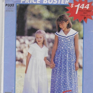 May include: A vintage McCall's sewing pattern for children's dresses. The pattern features two girls holding hands, one in a white dress and the other in a blue floral print dress. The pattern is labeled "P332 CHILD" and includes the text "Easy stitch 'n save".