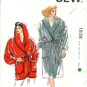 May include: Kwik Sew pattern 1938 featuring illustrations of two robes. One robe is red with a hood, the other is blue-gray with a shawl collar. The pattern includes sizes XS to XL.