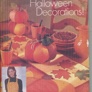 May include: Butterick pattern for Halloween decorations. The package features a pumpkin, mugs, and a pie, with the text "Halloween Decorations!" and "Halloween à la maison!" printed on the front. The pattern includes a one-size apron.