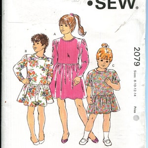 May include: Kwik Sew pattern 2079 for girls' dresses. The illustration shows three girls wearing different dress styles. The pattern includes sizes 8-10-12-14. The pattern is designed by Kerstin Martensson.