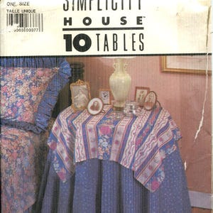 Könnte beinhalten: Simplicity House 10 Tables Schnittmuster. Das Bild zeigt einen Tisch mit einer blauen Tischdecke und einem Tischläufer mit Blumenmuster. Die Modellnummer ist 8418 und es ist Einheitsgröße. Der Text "Simplicity House" ist sichtbar.
