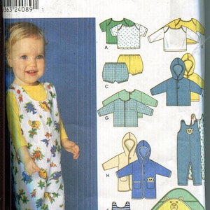 May include: Simplicity sewing pattern for children's clothing. The pattern includes options for tops, shorts, overalls, and hooded jackets. The image shows a child wearing a dinosaur-themed jumpsuit. The pattern sizes range from XXS to L.