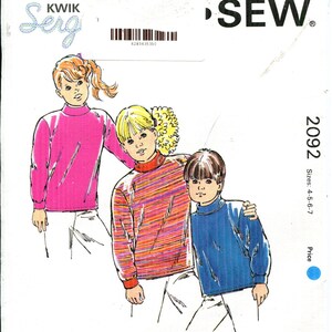 May include: A vintage Kwik Sew sewing pattern, pattern number 2092, with illustrations of children in turtleneck tops. The pattern sizes are 4-5-6-7. The Kwik Sew logo is displayed on the pattern.