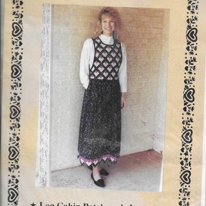 May include: A woman wearing a black and white patchwork jumper dress. The dress has a geometric pattern on the bodice and a floral pattern on the skirt. The text "Patchwork Possibilities" and "Log Cabin Patchwork Jumper" are visible.