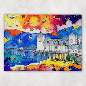 May include: Colorful watercolor painting of a pier extending into the ocean, with sailboats, fish, and a vibrant sunset. The pier has a white building with a gray roof. The artwork features bright blues, oranges, yellows, and purples.