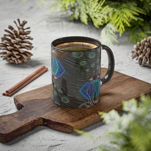 May include: A black coffee mug with a colorful geometric pattern. The mug is filled with coffee and steam is rising from the top.