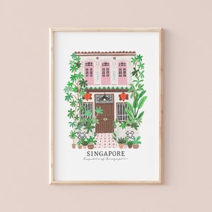 May include: A framed illustration of a pink and white building with a brown door and green plants. The text "SINGAPORE" and "Republic of Singapore" is below the building.