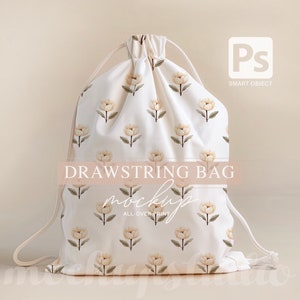 May include: White drawstring bag mockup featuring a floral pattern of light yellow flowers on a white background. The text "DRAWSTRING BAG MOCKUP ALL-OVER PRINT" is printed on the bag.