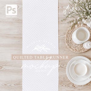 May include: White quilted table runner mockup on a light wood surface with white plates and a white cup on a woven placemat. The table runner has a chevron pattern.