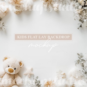 May include: A white background with a teddy bear and white flowers around the edges. The text "KIDS FLAT LAY BACKDROP MOCKUP" is in the centre of the image.
