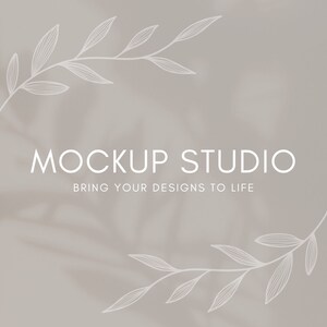 May include: A light gray background with a white floral design on the top and bottom. The text "MOCKUP STUDIO" is centered in the middle of the image, with the text "BRING YOUR DESIGNS TO LIFE" centered below it.