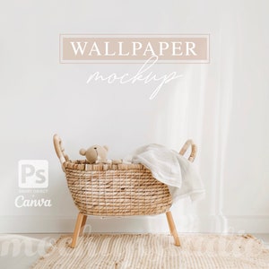 May include: A white wall with the text "WALLPAPER mockup" in a light brown rectangle. A wicker basket with a teddy bear inside and a white blanket is in the foreground. The basket is on a light brown rug.