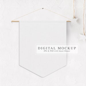 May include: White canvas banner mockup hanging on a white textured wall with a wooden dowel rod and string with white star ornaments. The banner is blank and ready for your design.  DIGITAL MOCKUP JPG & PSD with Smart Object