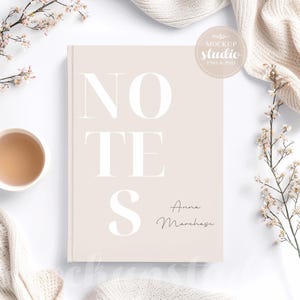 May include: Beige notebook mockup with the word 'NOTES' in a bold, sans-serif font.  The name 'Anna Marches' is written in a smaller, elegant script font at the bottom. The notebook is surrounded by soft, neutral-toned fabrics and delicate floral accents.  The text 'MOCKUP STUDIO PNG & PSD' is visible on a circular logo.