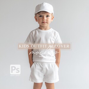 May include: A white t-shirt and white shorts with a white baseball cap on a child model.  KIDS OUTFIT ALLOVER MOCKUP PNG PSD is written on the image.