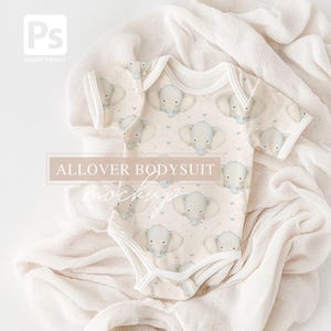 May include: A baby bodysuit featuring a repeating pattern of light blue elephants on a cream backdrop. The short-sleeved onesie has white trim and is displayed on a soft, cream-coloured fabric. The text "ALLOVER BODYSUIT mockup" is visible.