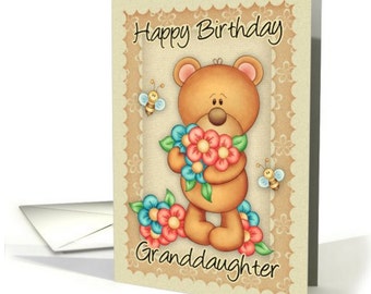 May include: A birthday card featuring a brown teddy bear holding a bouquet of pink, red, and blue flowers. The card has a scalloped border and the text "Happy Birthday Granddaughter" in brown cursive.